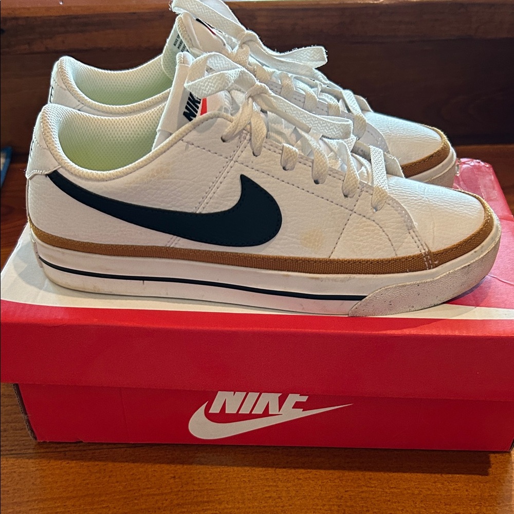 Nike White Low-Top Sneakers with Black Swoosh and Brown Trim